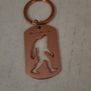 A keychain with an image of a bigfoot on it.