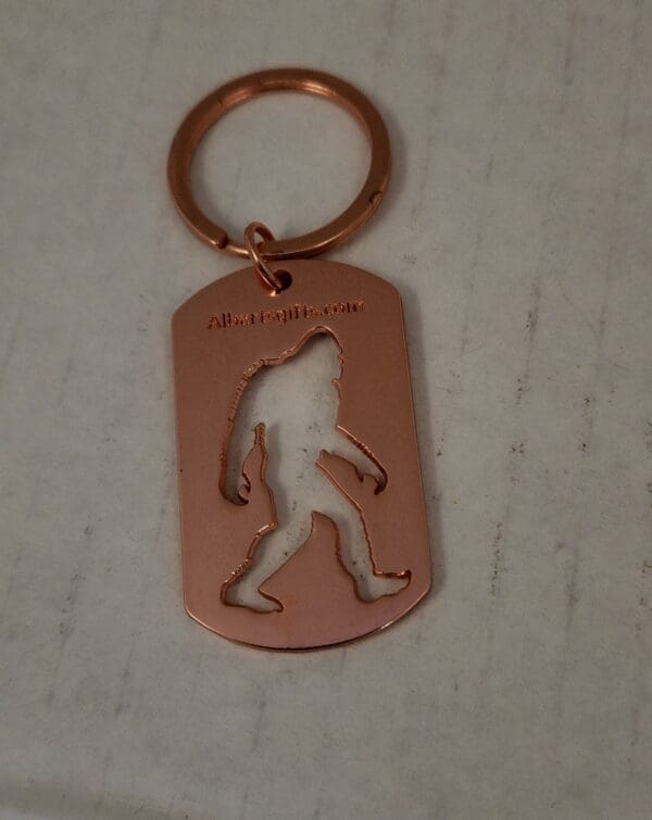 A keychain with an image of a bigfoot on it.