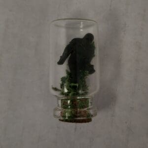 A glass bottle with a gorilla inside of it